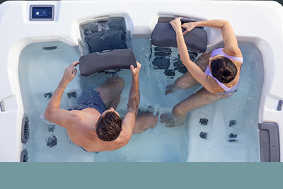 Couple switching their Bullfrog Spas jetpaks from within the Hot Tub