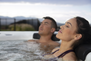 Couple relaxing in Bullfrog Spas Hot Tub - Available at Skillful Home Portland Maine