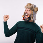 Enthusiastic Man with Christmas Balls hanging from hat