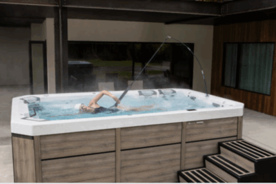 Woman swimming in her Bullfrog Spas Swim Spa - available at Skillful Home Recreation in Portland, Maine